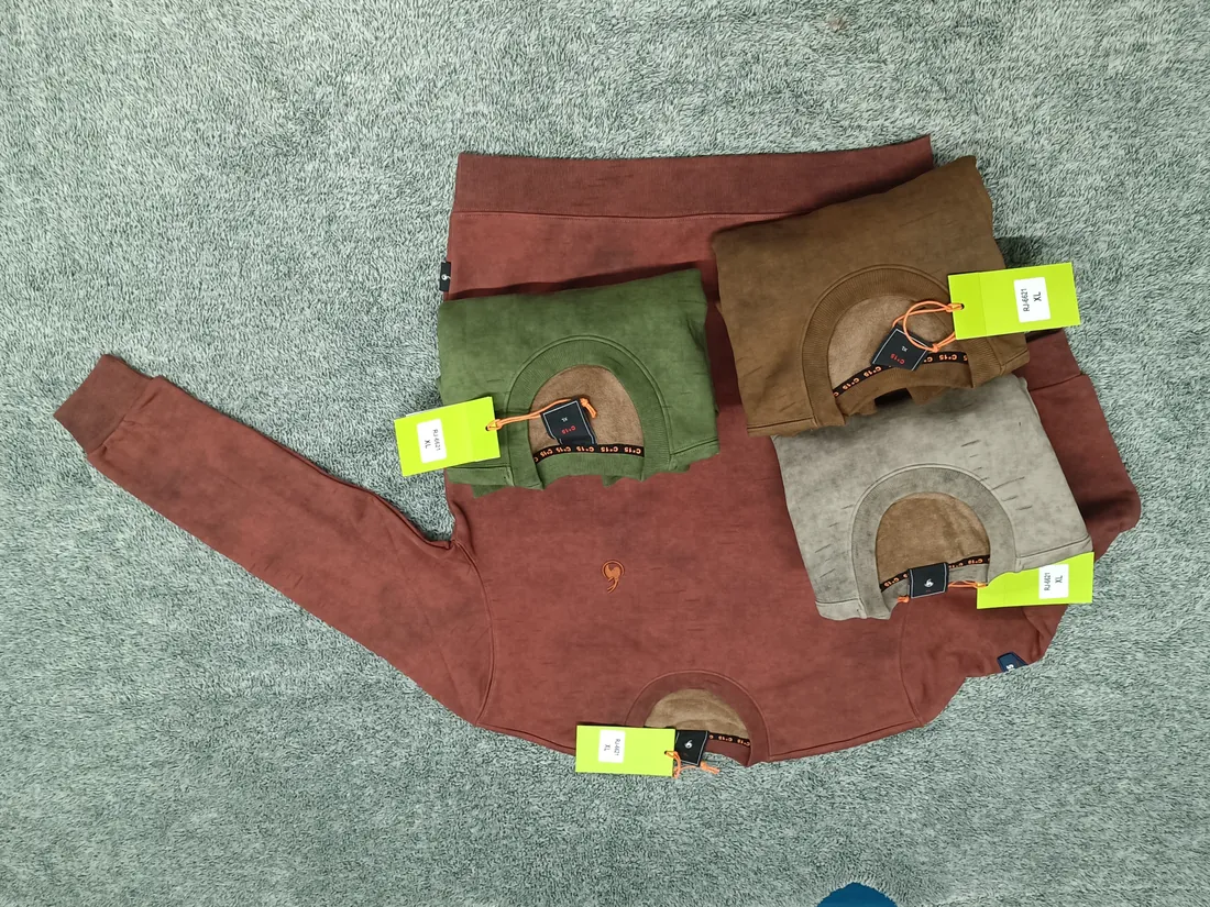 Rust and terracotta C-15 long-sleeve shirts laid out with swing tags on carpet