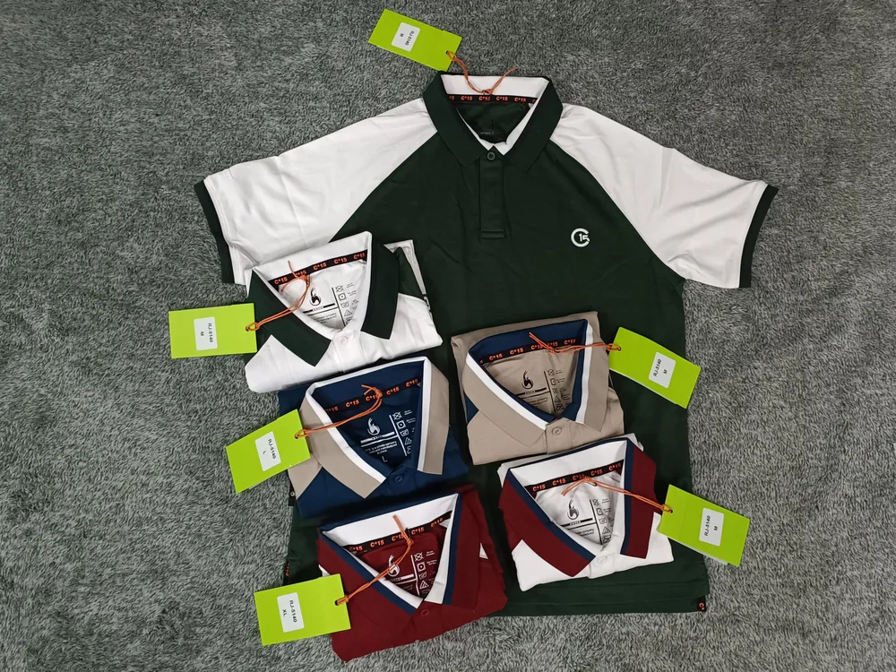 Green and white raglan C-15 polo with folded contrast-collar colourways on carpet