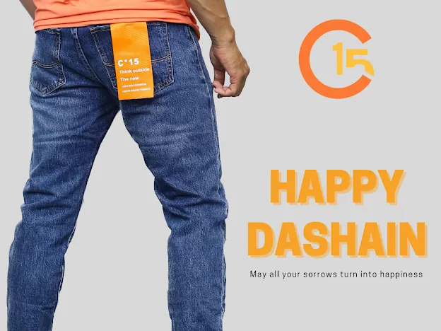 C-15 Happy Dashain greeting graphic showing the back of blue jeans with the orange C-15 pocket tag