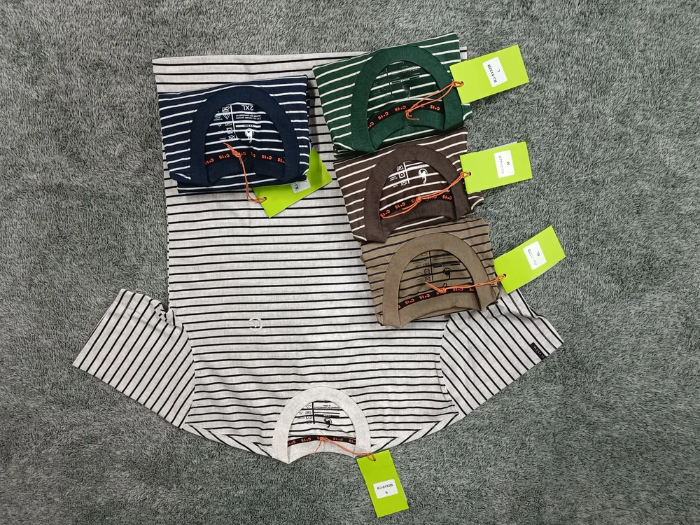 White and navy pinstripe C-15 t-shirts with folded colourways on grey carpet