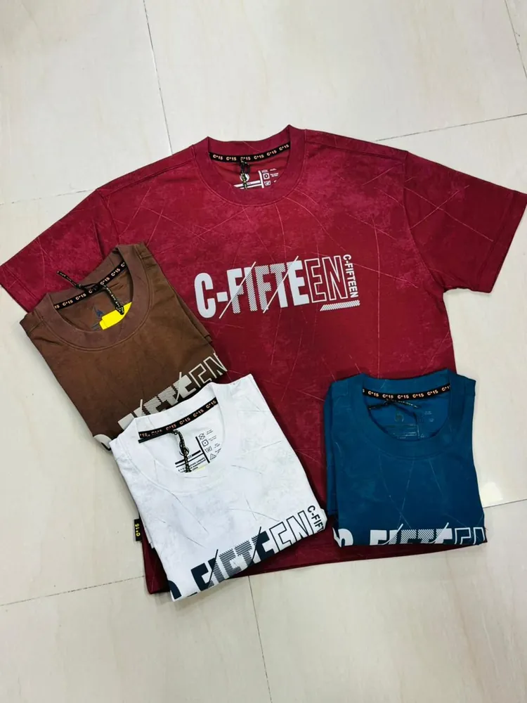 Red C-Fifteen t-shirt laid out with folded brown, white and teal colourways