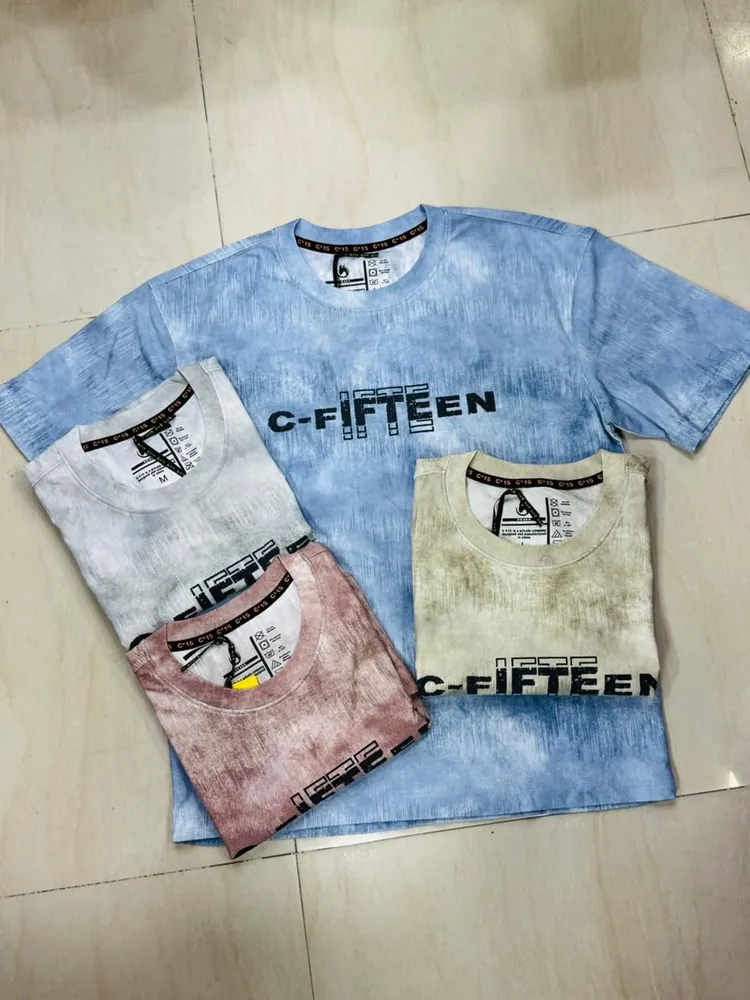 Sky-blue tie-dye C-Fifteen t-shirt with folded tie-dye colourways on tile