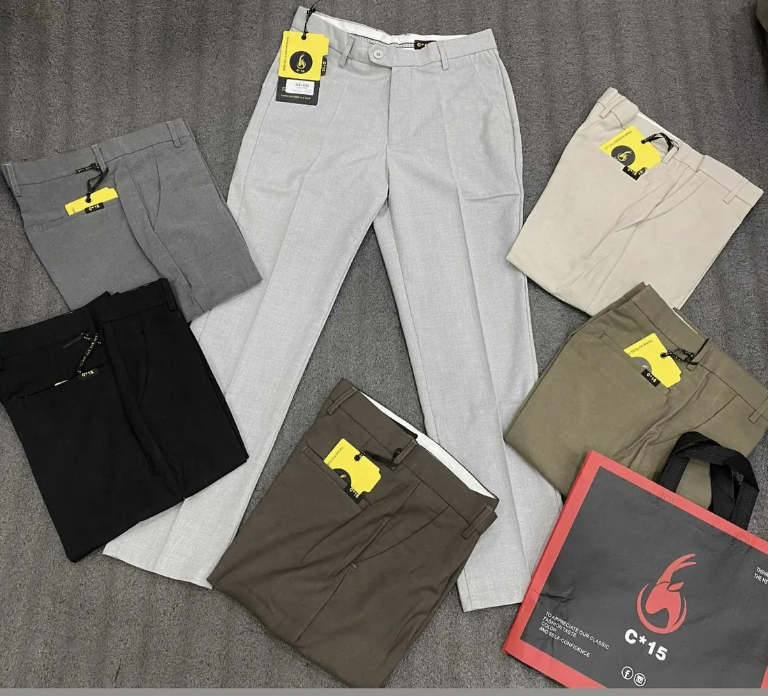 Flat lay of C-15 cotton trousers in grey, beige, black and olive with the C-15 carry bag